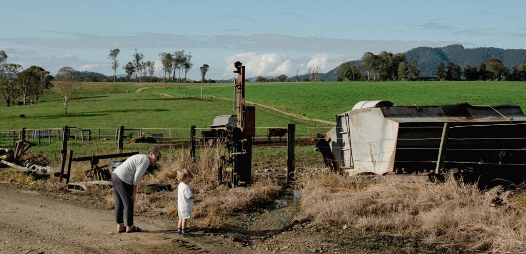 A serene rural landscape with a woman and child on a farm in Gloucester, Australia.