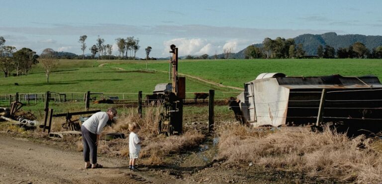 A serene rural landscape with a woman and child on a farm in Gloucester, Australia.